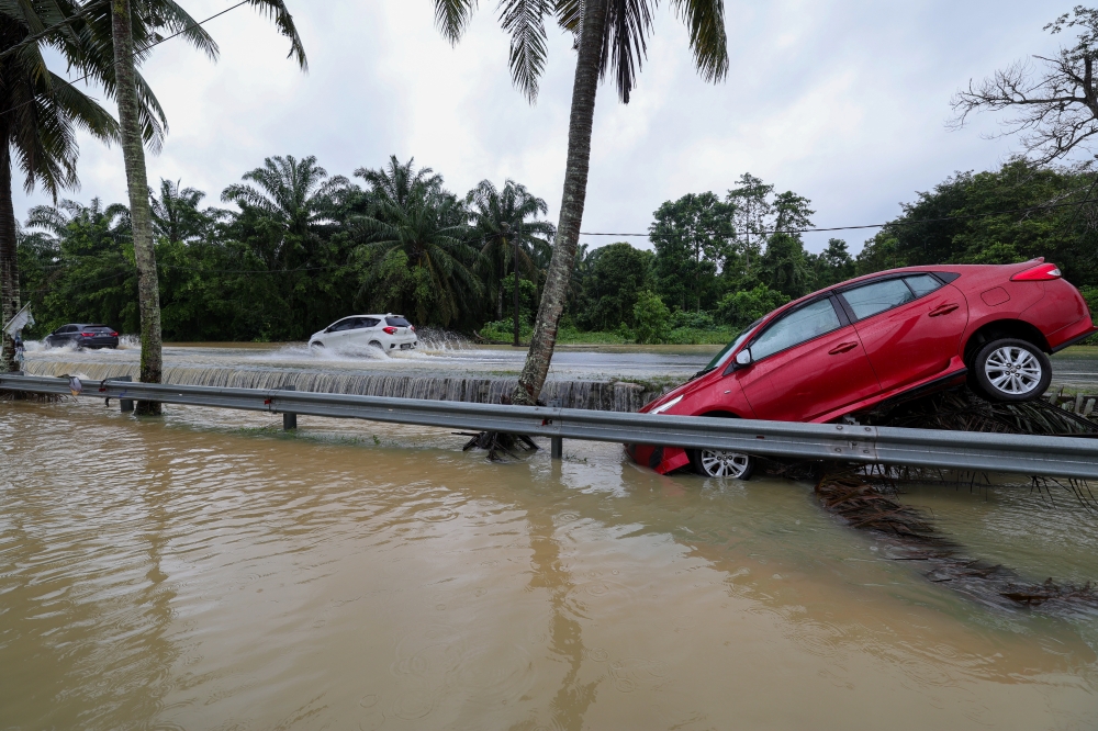A car falls victim to floodwaters in Taman Mawai, Kota Tinggi January 11, 2025. — Bernama pic