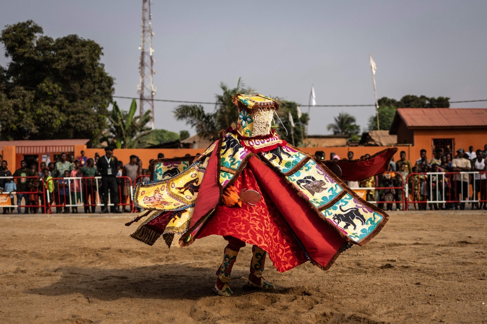 An Egungun, a visible manifestation of the spirits of departed ancestors who periodically revisit the human community for remembrance, celebration, and blessings dances in Ouidah, on January 9, 2025 during the first day of the Voodoo Festival. — AFP pic