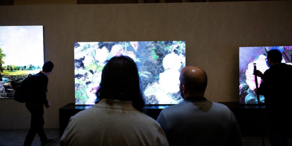 People walk past TV screens at the Samsung First Look preview at the Caesars Palace resort a pre-show for the Consumer Electronics Show in Las Vegas January 7, 2024. — AFP pic
