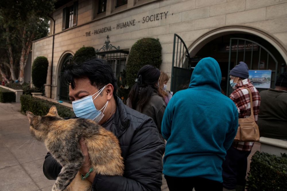 Edgar Hernandez waits outside the Pasadena Humane Society to surrender his cat, after evacuating his home in Altadena, following powerful winds fuelling devastating wildfires in the Los Angeles area in Pasadena, January 8, 2025. — Reuters pic