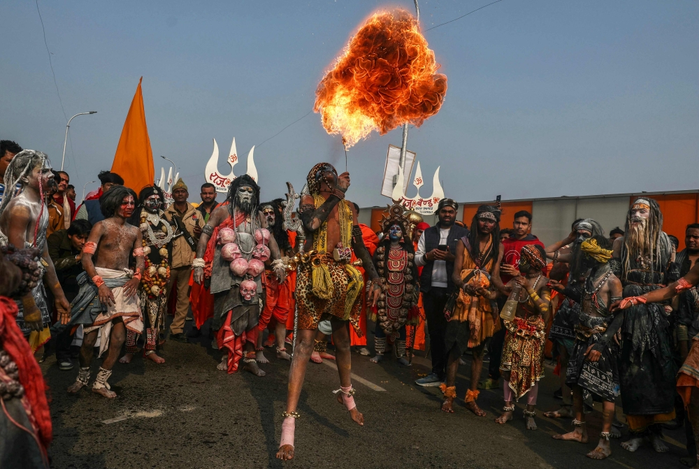 A Hindu devotee performs fire-breathing act during a religious procession ahead of the Maha Kumbh Mela festival in Prayagraj January 10, 2025. — AFP pic