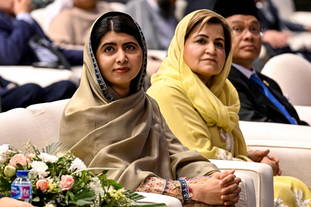 Nobel Peace Prize Laureate Malala Yousafzai (left) looks on during an international summit on 'Girls? Education in Muslim Communities', in Islamabad on January 12, 2025. — AFP pic