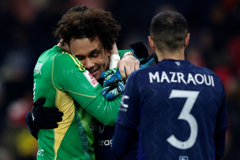 Manchester United's Dutch striker Joshua Zirkzee celebrates with Manchester United's Turkish goalkeeper Altay Bayindir after scoring his penalty. — AFP pic