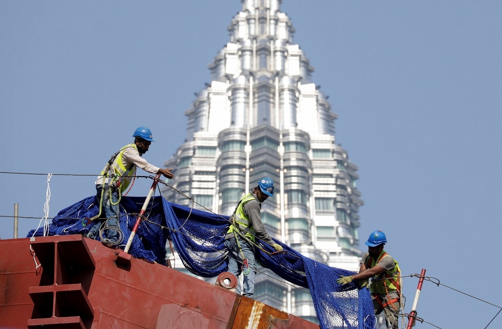 A file photograph shows workers at a construction site in Kuala Lumpur, on October 12, 2023. — Reuters pic 