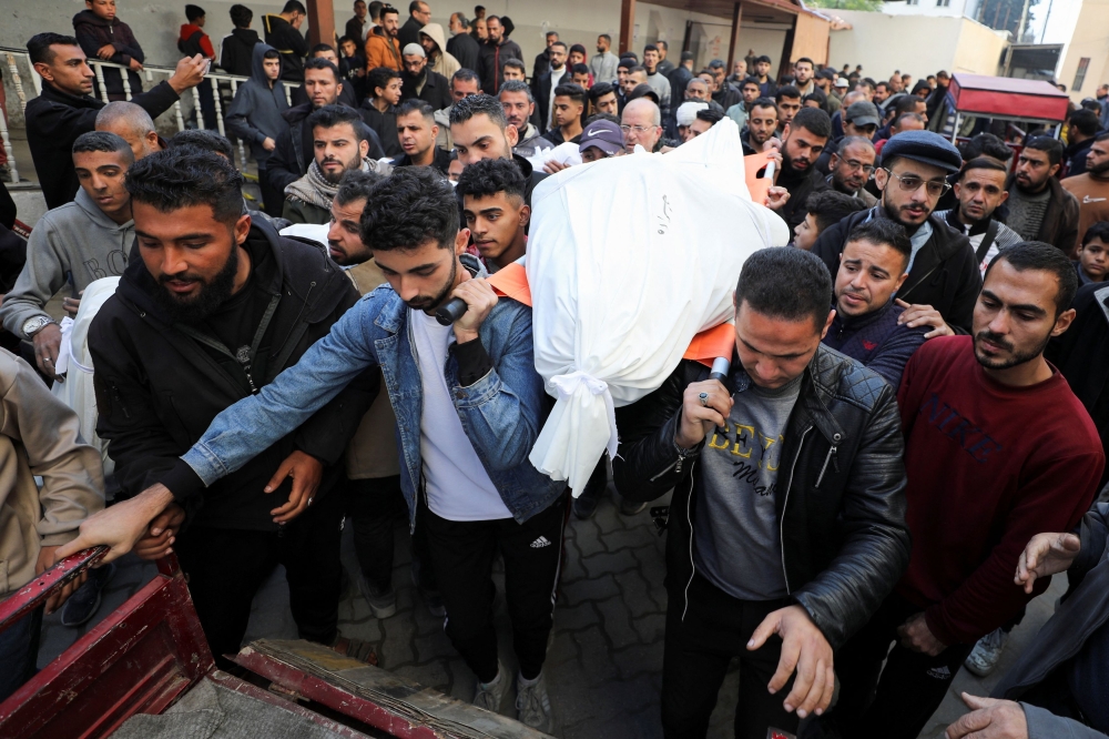 Men carry the bodies of Palestinians killed in Israeli strikes, amid the ongoing conflict between Israel and Hamas, at Al-Ahli Arab Baptist Hospital in Gaza City, January 13, 2025. — Reuters pic 
