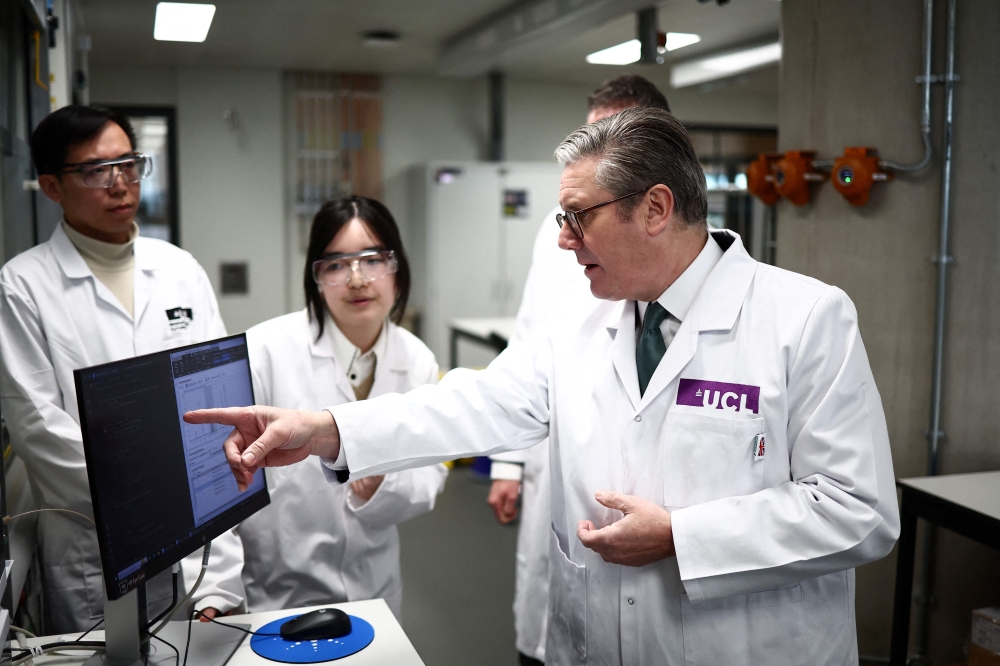 Britain's Prime Minister Keir Starmer (right) speaks with researches and professors during a visit of the Manufacturing Futures Lab at Univeristy College London, in London, on January 13, 2025. — AFP pic