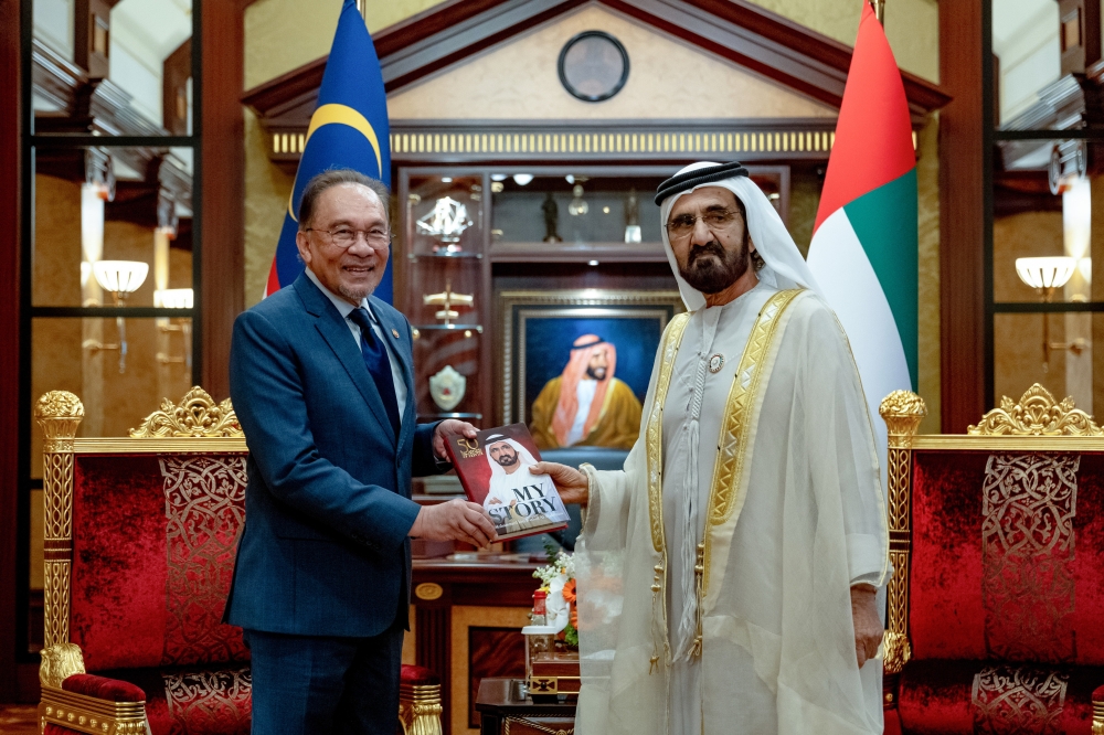 Prime Minister Datuk Seri Anwar Ibrahim (left) receives a book from the Ruler of Dubai Sheikh Mohammed Rashid Al Maktoum at the Za’abeel Palace in Dubai on Jan 13, 2025. — Bernama pic