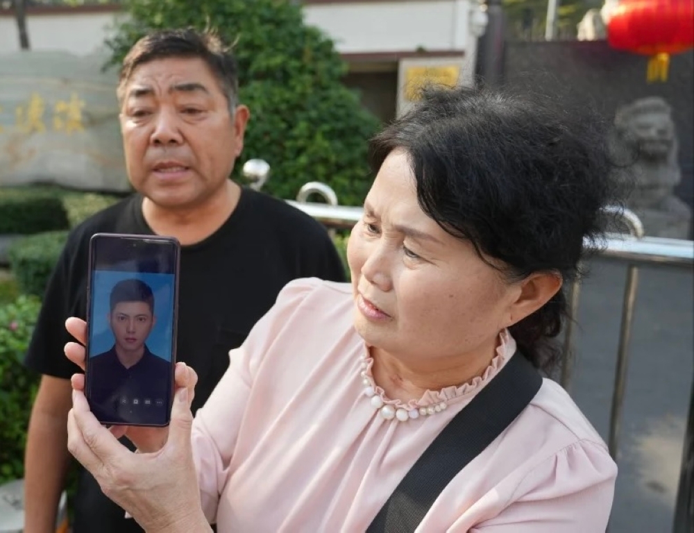 The couple made a public plea outside the Chinese embassy in Bangkok. — Pic via X