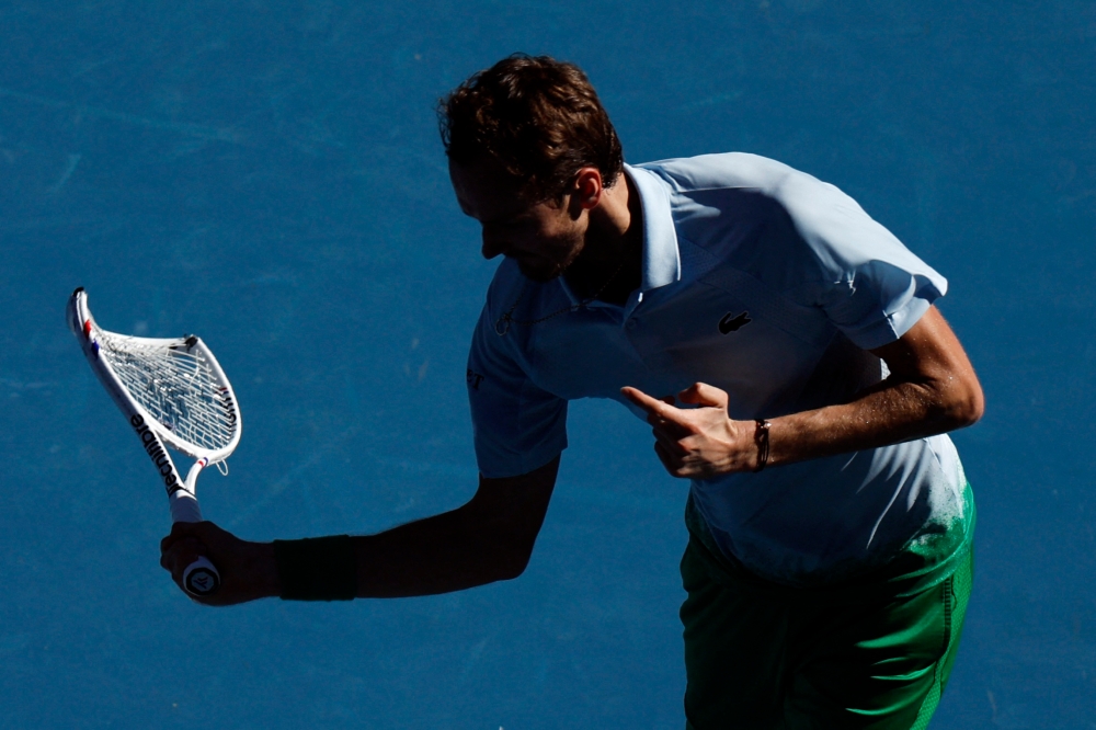 Russia’s Daniil Medvedev reacts while holding his smashed racquet during his first round match against Thailand’s Kasidit Samrej at Melbourne Park, Melbourne, January 14, 2025. — Reuters pic