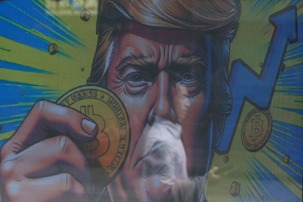 An illustration featuring US President-elect Donald Trump holding Bitcoin is displayed outside a cryptocurrency exchange in Hong Kong, China, December 5, 2024. — Reuters pic