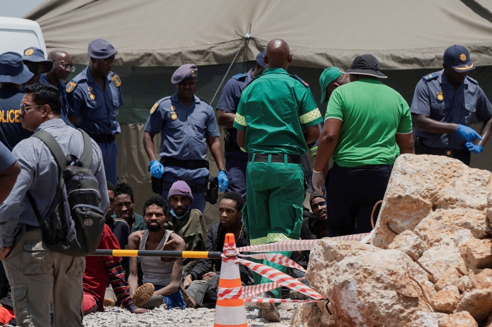 Rescued miners are seen as they are processed by police after being rescued at the mine shaft where rescue operations are ongoing as attempts are made to rescue illegal miners who have been underground for months, in Stilfontein, South Africa, January 14, 2025. — Reuters pic