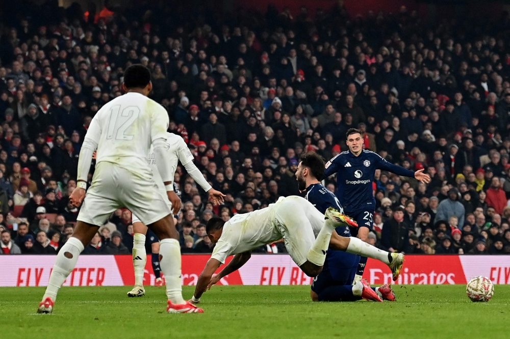 Manchester United’s Bruno Fernandes fouls Arsenal’s Gabriel Jesus resulting in Jesus being stretchered off injured during the English FA Cup third round match at the Emirates Stadium in London January 12, 2025. — AFP pic