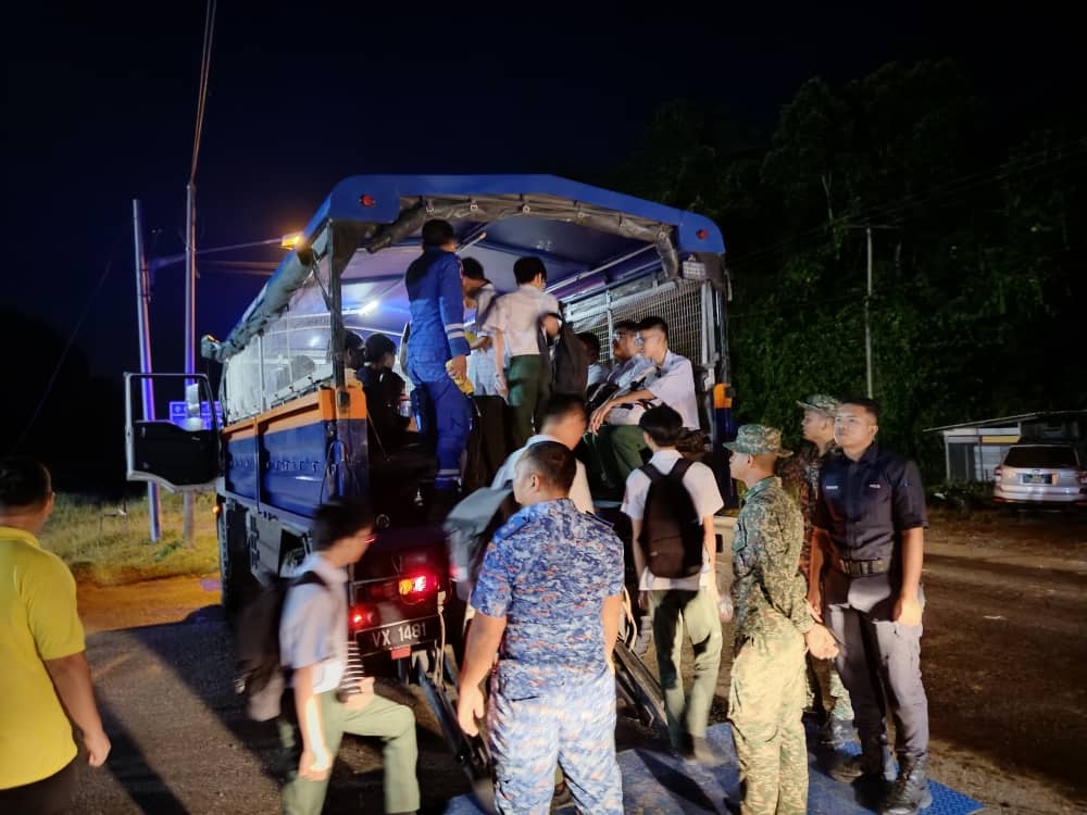 SMK Kwong Hua students and teachers board the Civil Defence Force’s five-tonne truck to go to school in Sibu on January 15, 2025 due to flooding. — Picture courtesy of the Sibu Civil Defence Force