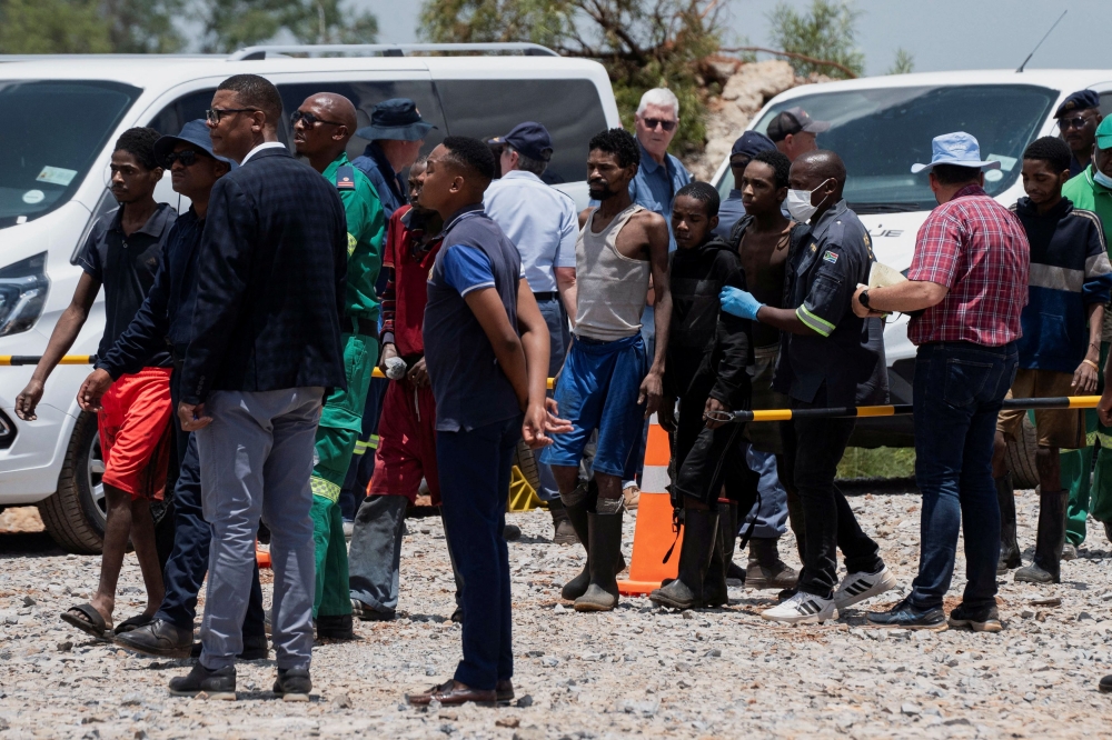 Rescued miners are seen as they are processed by police after being rescued at the mine shaft where rescue operations are ongoing as attempts are made to rescue illegal miners who have been underground for months, in Stilfontein, South Africa, January 14, 2025. — Reuters pic