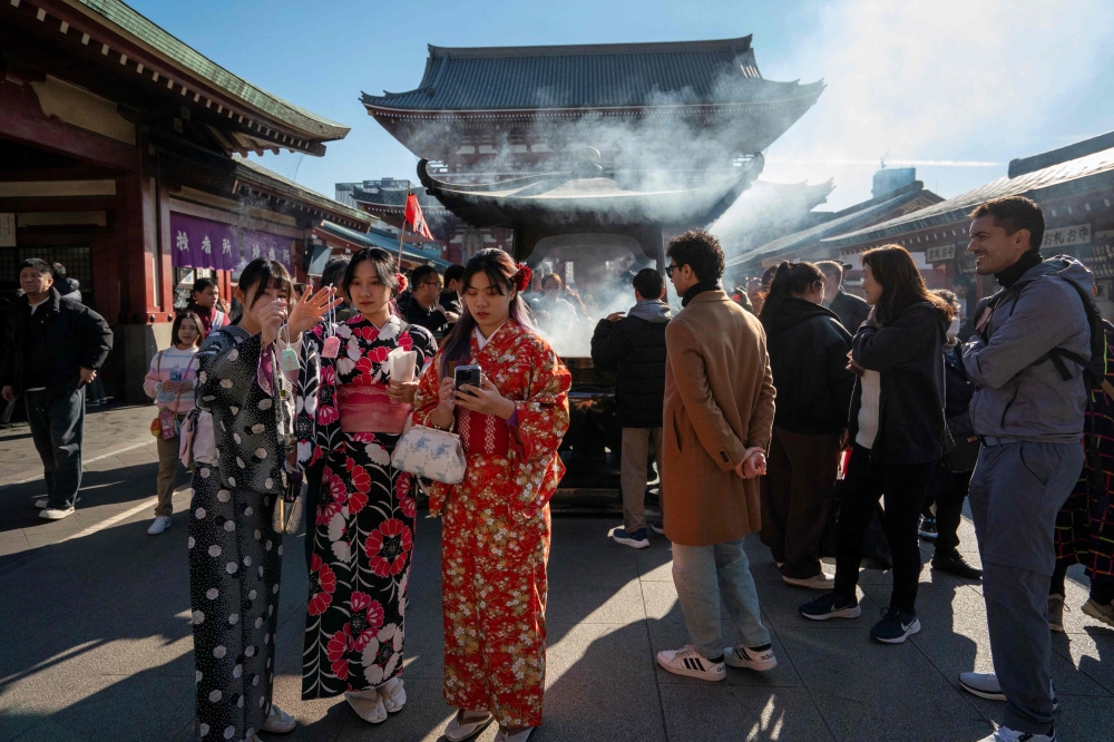 Tourists visit Sensoji Temple in Asakusa, Tokyo, January 14, 2025. — AFP pic