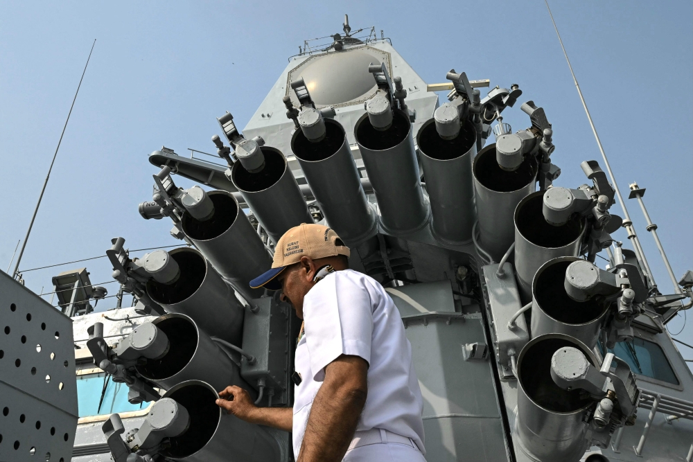 A crew member onboard the naval combatant ‘INS Surat’, a stealth guided missile destroyer of the Indian Navy, inspects the Indigenous Rocket Launchers (IRL) on the warship’s deck at the Naval Dockyard in Mumbai January 11, 2025. — AFP pic