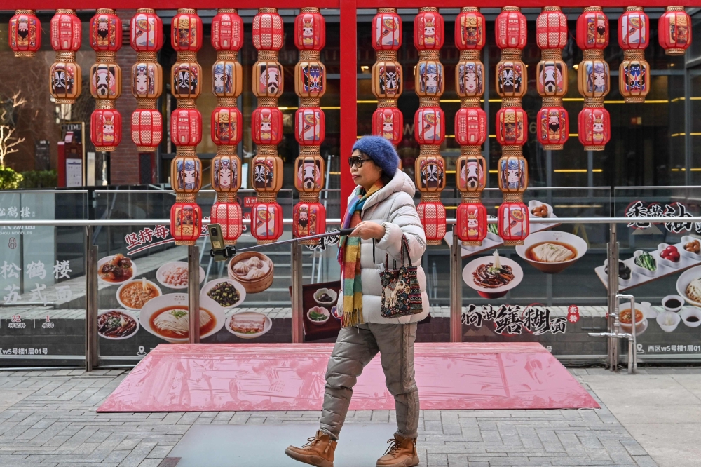 A woman visits the popular Qianmen tourist area in Beijing on January 13, 2025. — AFP pic 