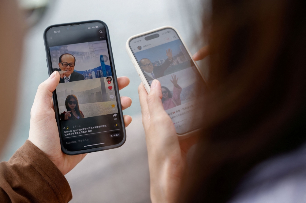 Laura Li, 28, and her cousin Diego Deng, 20, search on the Chinese social media platform Xiaohongshu, in Hong Kong, China, April 30, 2024. — Reuters pic 