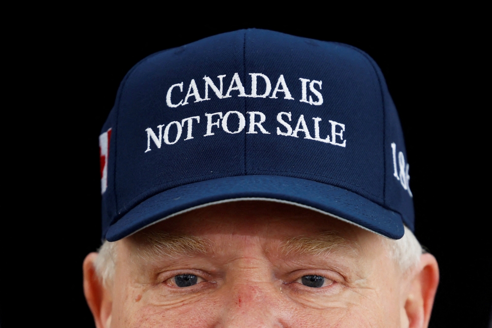 Ontario Premier Doug Ford, wearing a ‘Canada is not for sale’ hat, speaks to journalists before a provincial and territorial leaders meeting in Ottawa January 15, 2025. — Reuters pic