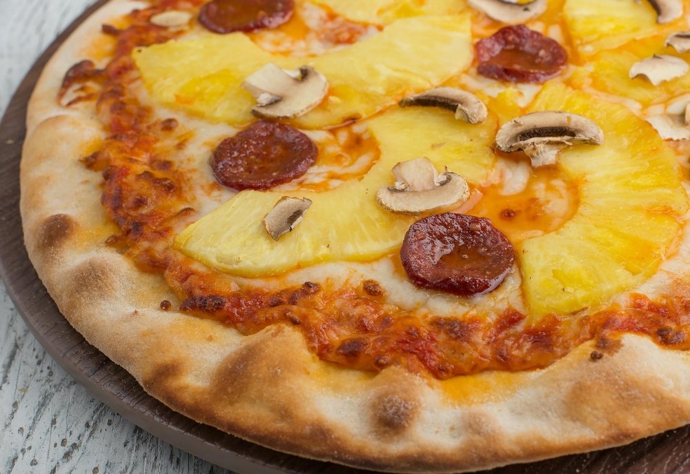 Pineapple lovers at Lupa Pizza in Norwich, eastern England will now face a £100 bill if they want the contentious fruit delivered on their pizza. — Picture from pexels.com