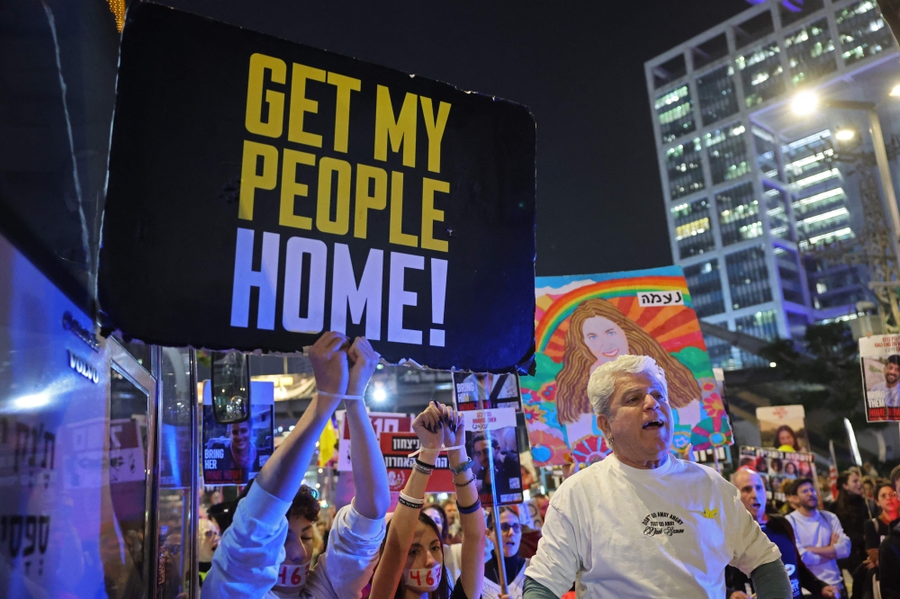 Demonstrators take part in a protest calling for action to secure the release of Israelis held hostage in Gaza since the October 2023, in front of the Israeli defence ministry in Tel Aviv on January 15, 2025. — AFP pic