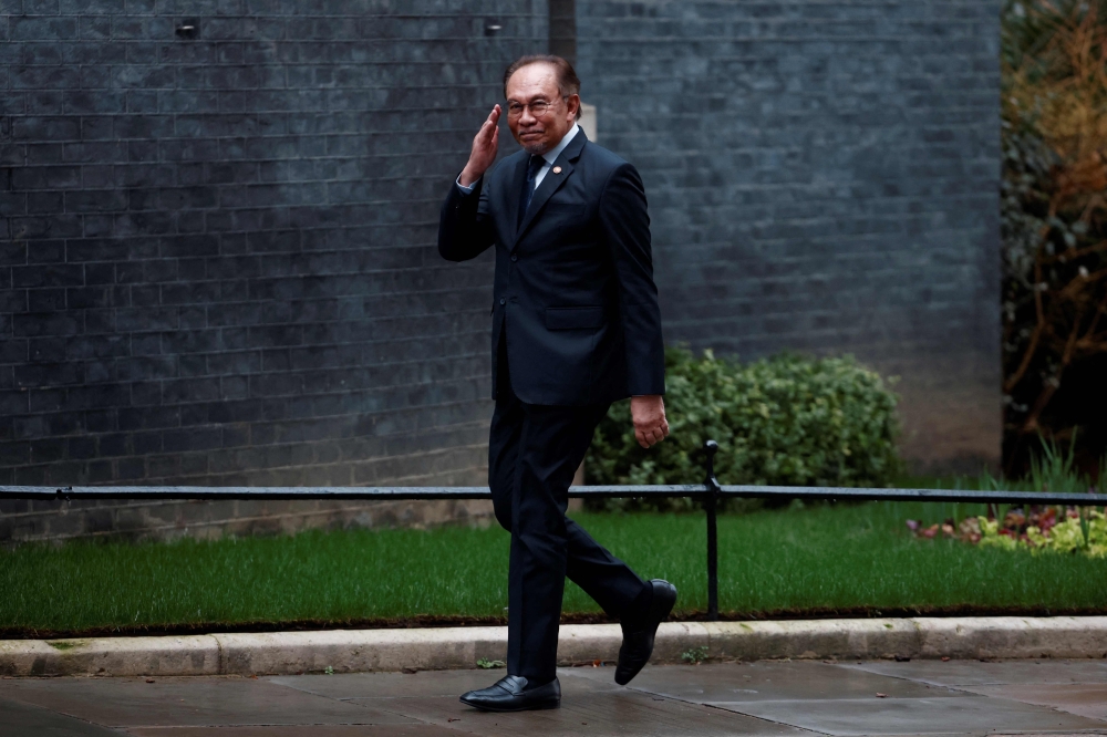 Malaysia’s Prime Minister Anwar Ibrahim gestures upon arrival to meet with his British counterpart at 10 Downing Street in central London on January 15, 2025. Anwar met industry players and institutional investors on the third day of his working visit to the United Kingdom (UK). — AFP pic