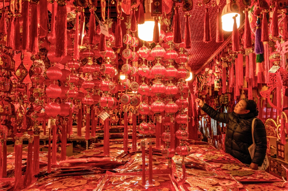 A customer shops for new year decorations, ahead of the upcoming Lunar New Year of the Snake, at a store in Nanjing January 15, 2025. — AFP pic