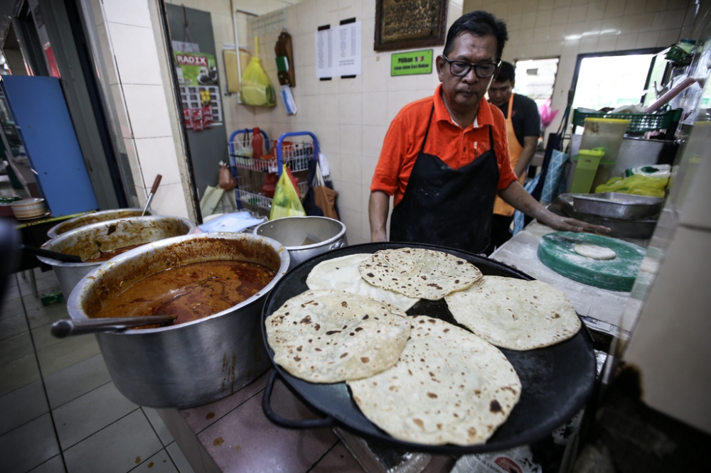 Capati is made with unleavened flour, toasted on a hot flat-top griddle. — Picture by Ahmad Zamzahuri