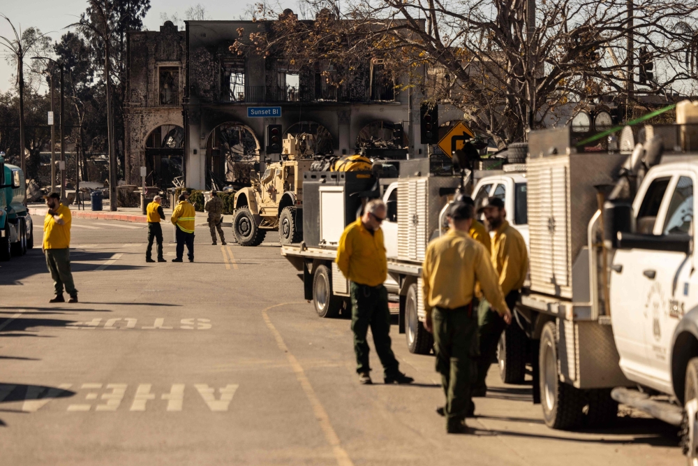 Private firefighting company employees, hired to protect Rick Caruso's Palisades Village mall. — AFP pic