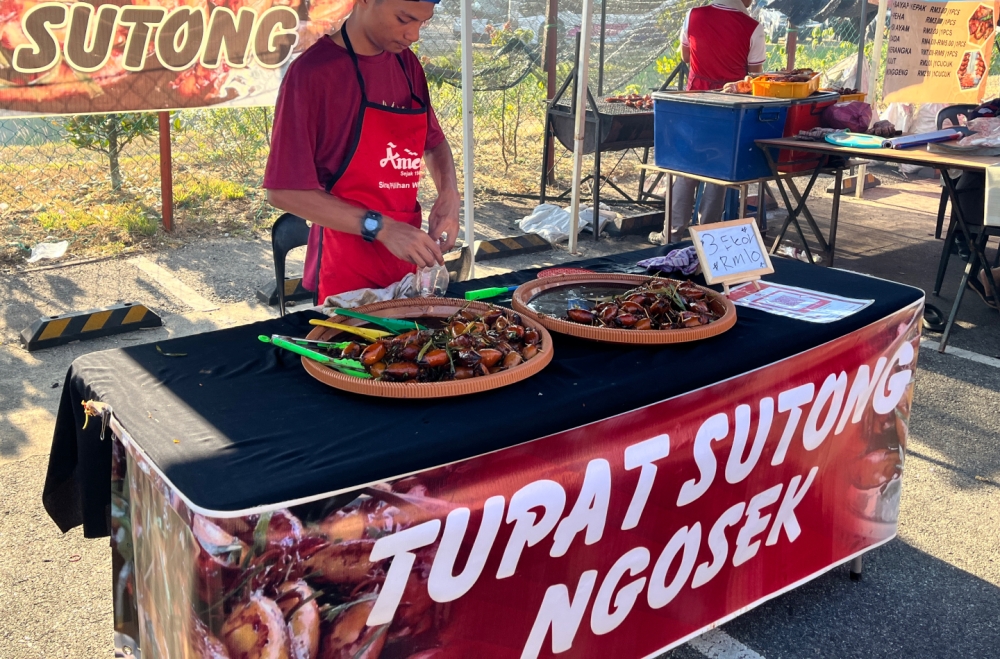A Ramadan bazaar seller selling ‘ketupat sotong’ in Tunjong, near Kota Baru. — Picture by Zurairi A.R.
