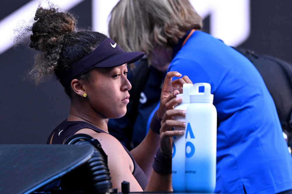 Japan's Naomi Osaka receives medical attention during her women's singles match against Switzerland's Belinda Bencic today. — AFP pic