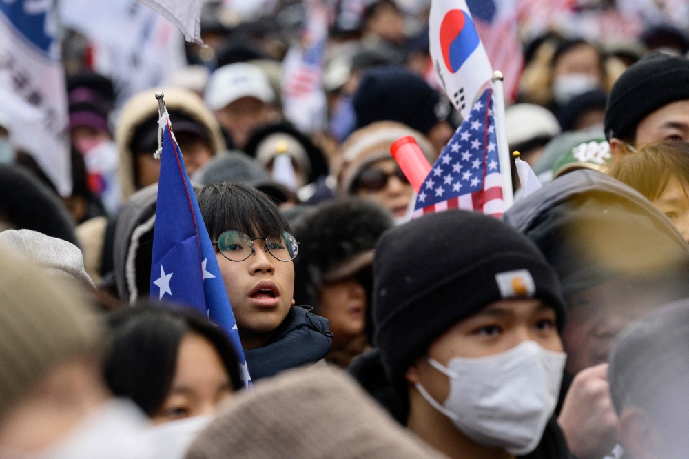 Supporters of impeached South Korean president Yoon Suk Yeol chant slogans during a rally outside the Seoul Central District Court in Seoul yesterday. — AFP pic
