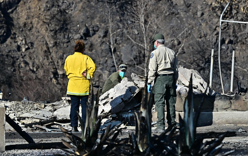 California State Parks personel look through the rubble of a burnt-out property from the Palisades Fire in Malibu. — Picture from AFP
