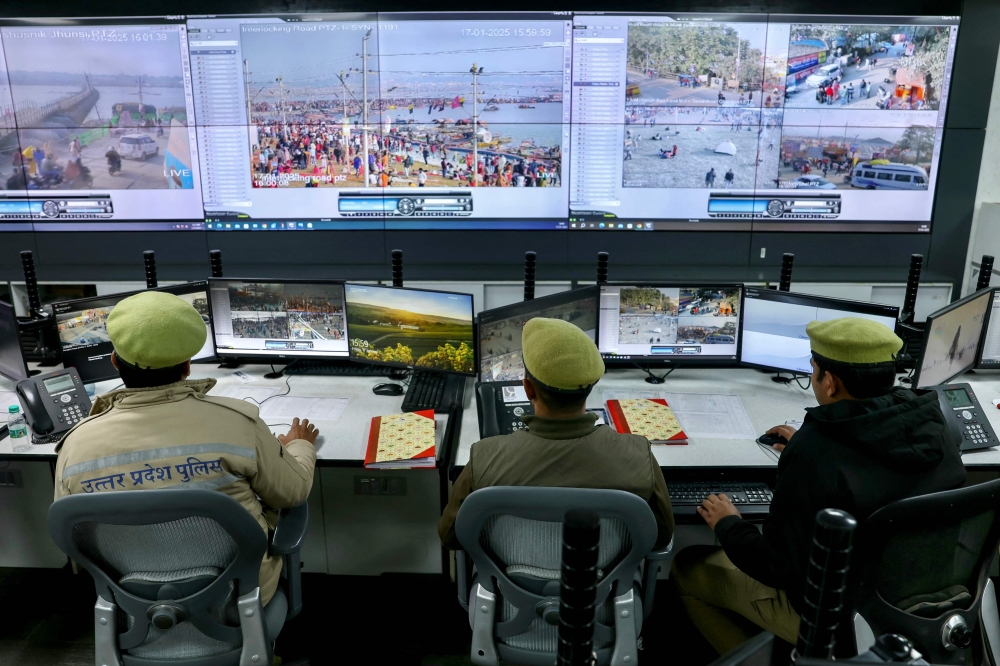 Police monitor the situation via screens at the Integrated Command and Control Center, set up to manage and control the crowd, during the Maha Kumbh Mela festival in Prayagraj. — AFP pic