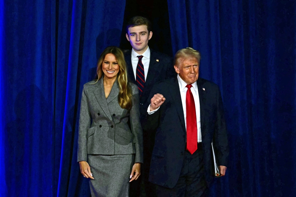 Donald Trump alongside his wife Melania Trump and his son Barron Trump. — AFP pic 
