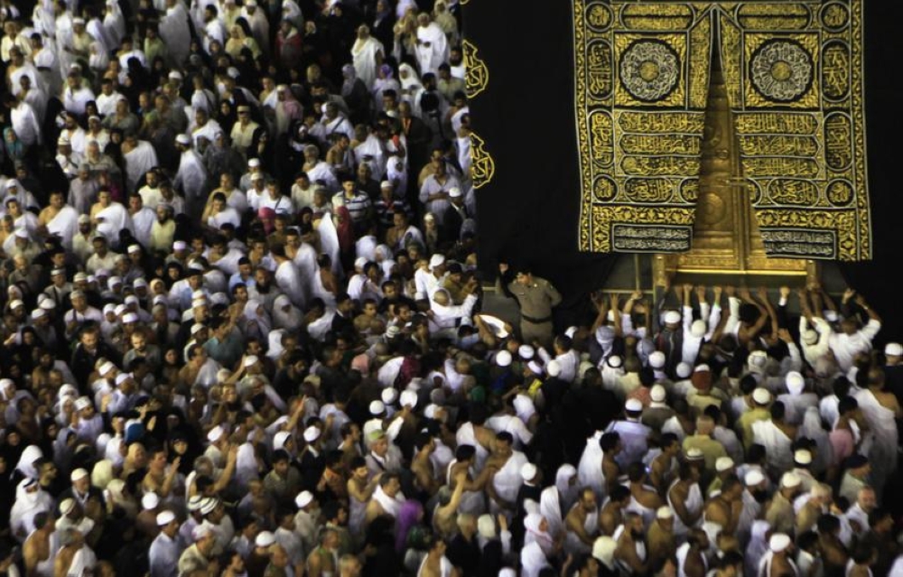 File photo of Muslims touching and praying at the door of the Kaaba, as well as kissing the Al-Hajr al-Aswad ‘Black Stone,’ during their Umrah Mawlid al-Nabawi pilgrimage in Mecca January 13, 2014. – Reuters pic