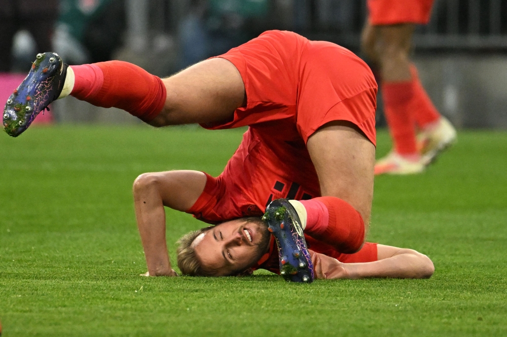 Bayern Munich’s  Harry Kane tumbles in the  German first division Bundesliga football match against  VfL Wolfsburg. — Picture from AFP 