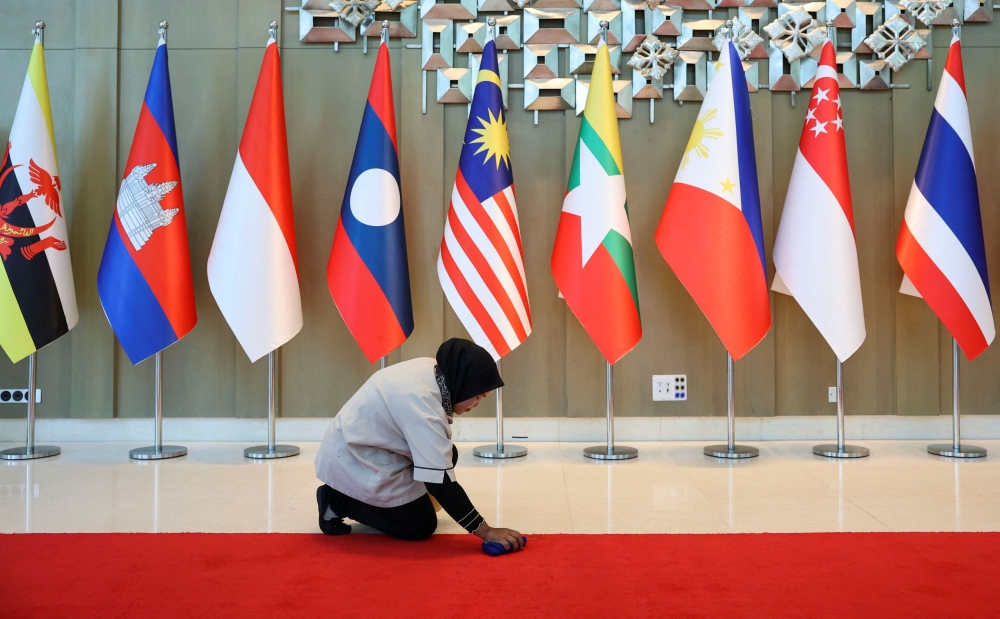 A worker cleans up the red carpet at the venue ahead of the Asean Foreign Ministers’ Retreat in Langkawi January 17, 2025. — Reuters pic