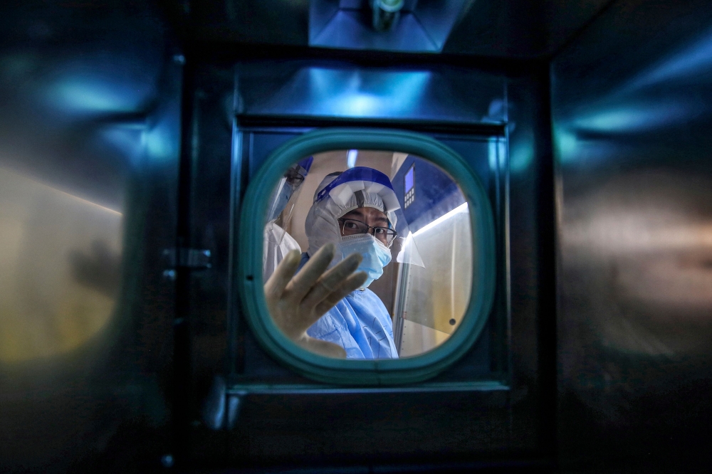 A medical staff member gestures inside an isolation ward at the Red Cross Hospital in Wuhan in China’s central Hubei province on March 10, 2020. — AFP file pic