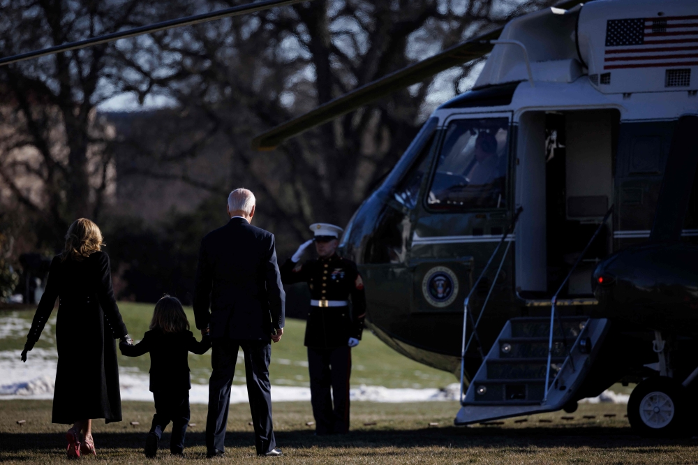 Outgoing US President Joe Biden, his wife Jill Biden, and grandson Beau, board Marine One on the South Lawn of the White House in Washington, DC. — AFP pic