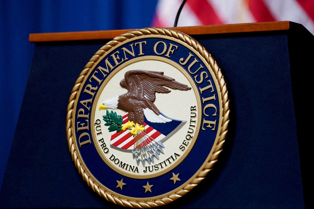 The seal of the U.S. Justice Department is seen on the podium in the Department's headquarters briefing room before a news conference with the Attorney General in Washington, January 24, 2023. — Reuters pic