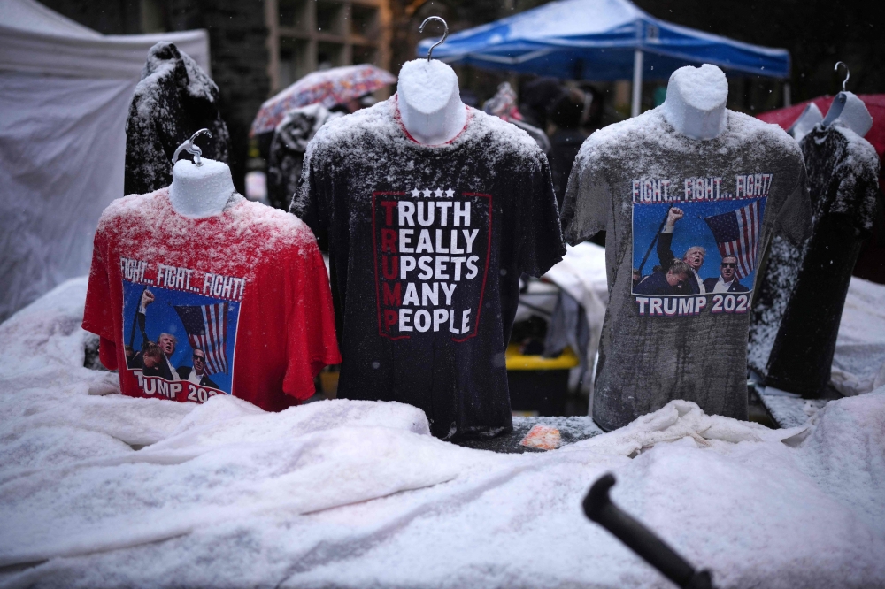 Donald Trump-related merchandise on sale outside the Capital One Arena for his victory rally. — Pic by AFP