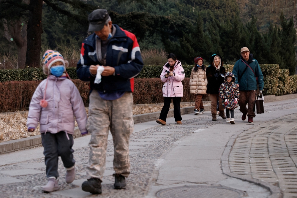 File picture of elderly people walking with children at a park in Beijing, China January 12, 2024. — Reuters pic 