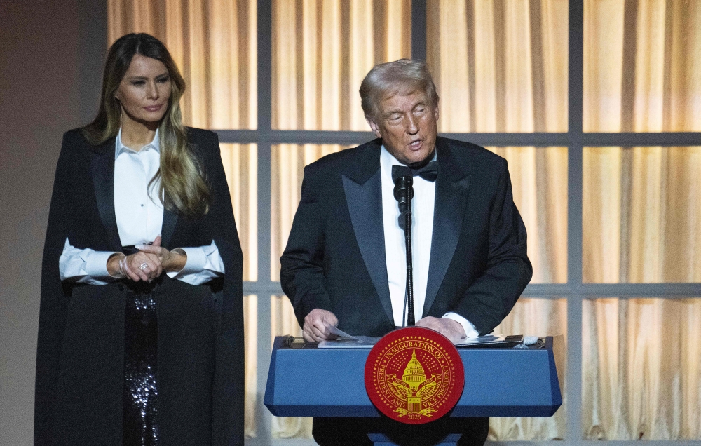 Melania Trump watches her husband, US President-elect Donald Trump, speak at a candlelight dinner at the National Building Museum, a day before his inauguration ceremony.— Pic by AFP