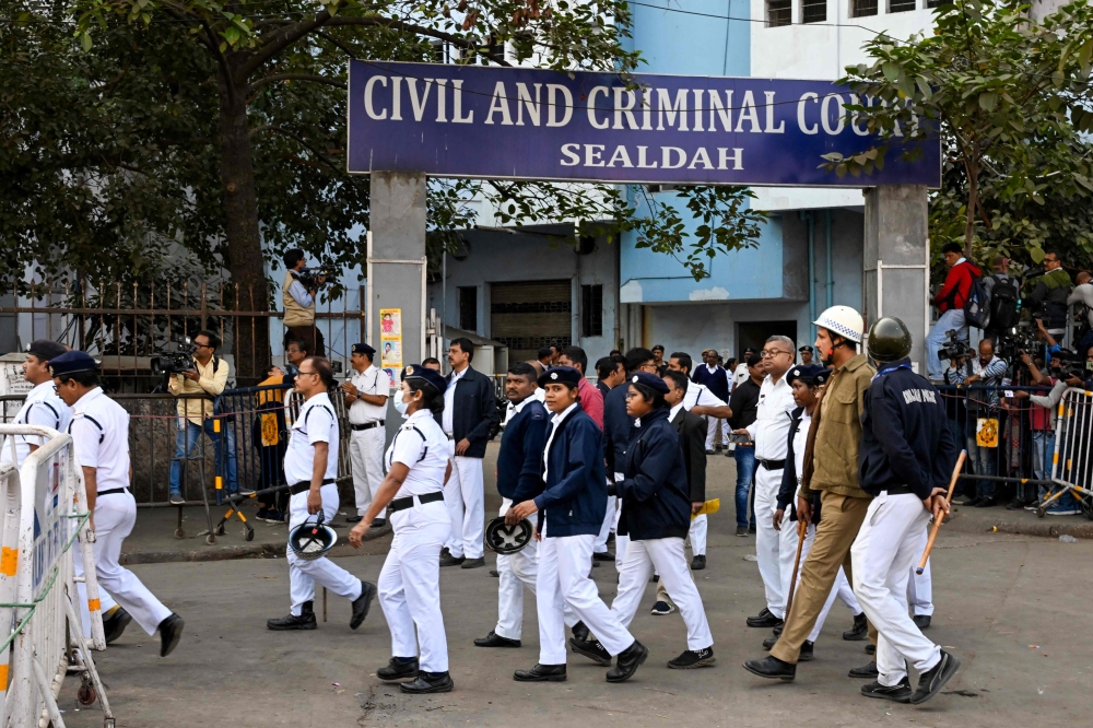 Police personnel stand guard at an entrance of Civil and Criminal Court Sealdah during the trial for the accused of rape and murder of an Indian doctor in Kolkata on January 18, 2025. An Indian court on January 18 convicted the lone accused in the rape and murder of a 31-year-old doctor that sparked nationwide protests and hospital strikes by doctors at last year. — AFP pic 