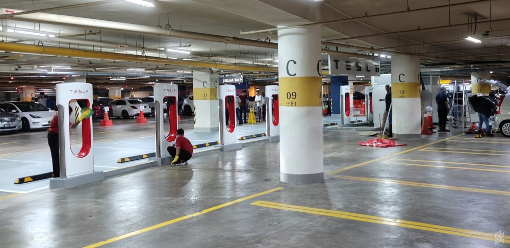 A Tesla supercharger station at Pavilion KL. Security, cleaning, and maintenance of parking facilities add to operational costs. 