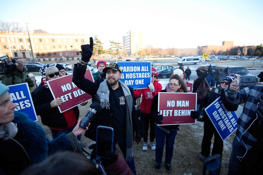 Joshua Macias (centre) gathers with other demonstrators outside the DC Central Detention Facility yesterday in Washington, DC— Pic by AFP