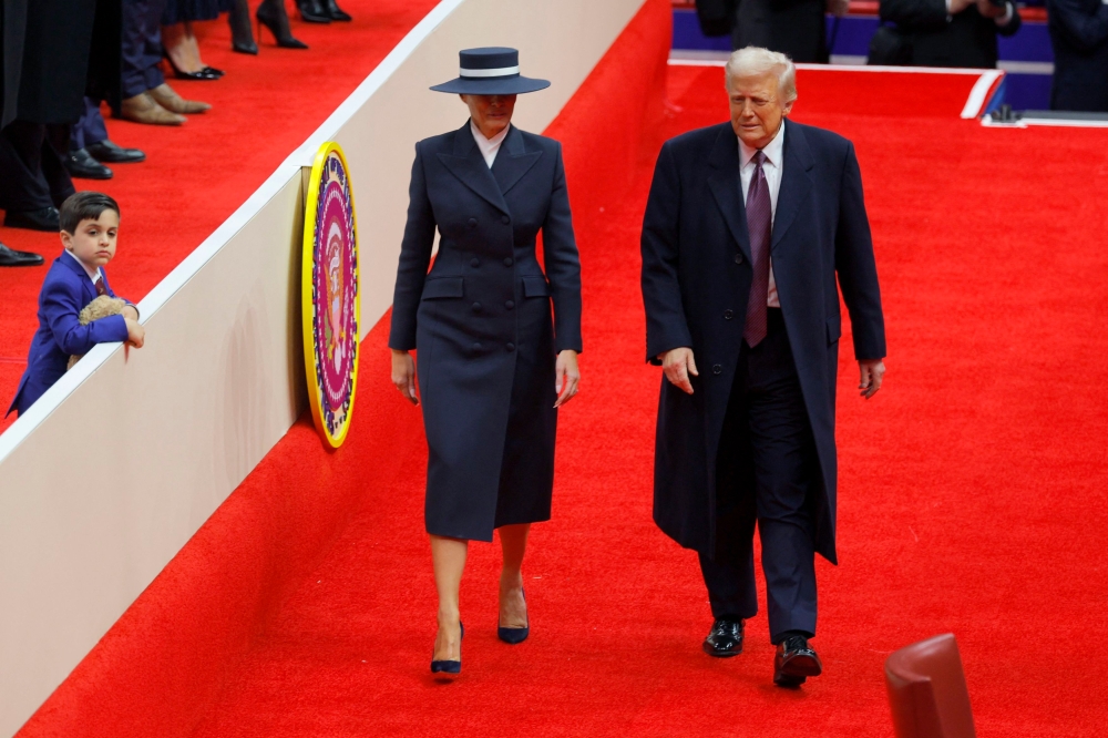 US President Donald Trump and first lady Melania Trump arrive at Capital One arena on the inauguration day of Trump's second presidential term, in Washington January 20, 2025. — Reuters pic  