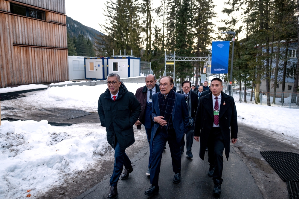 Prime Minister Datuk Seri Anwar Ibrahim walks to attend the media briefing session titled 'Unlocking ASEAN's Digital Future: Driving Inclusive Growth and Global Competitiveness' at the World Economic Forum (WEF) Annual Meeting 2025, held here yesterday.