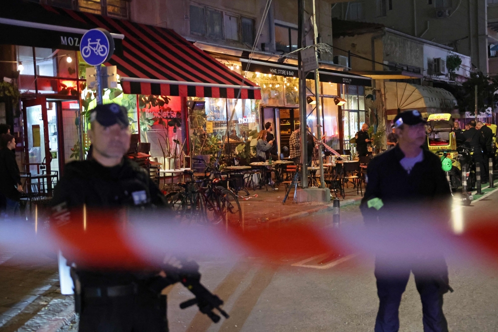 Members of Israeli security forces stand guard at the site of a stabbing attack in Tel Aviv. — Pic by  AFP